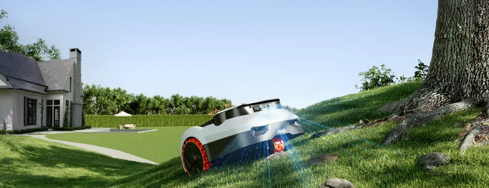 The Navimow i2 LiDAR Pro climbing a grassy slope near a large tree, its sensors scanning the ground ahead